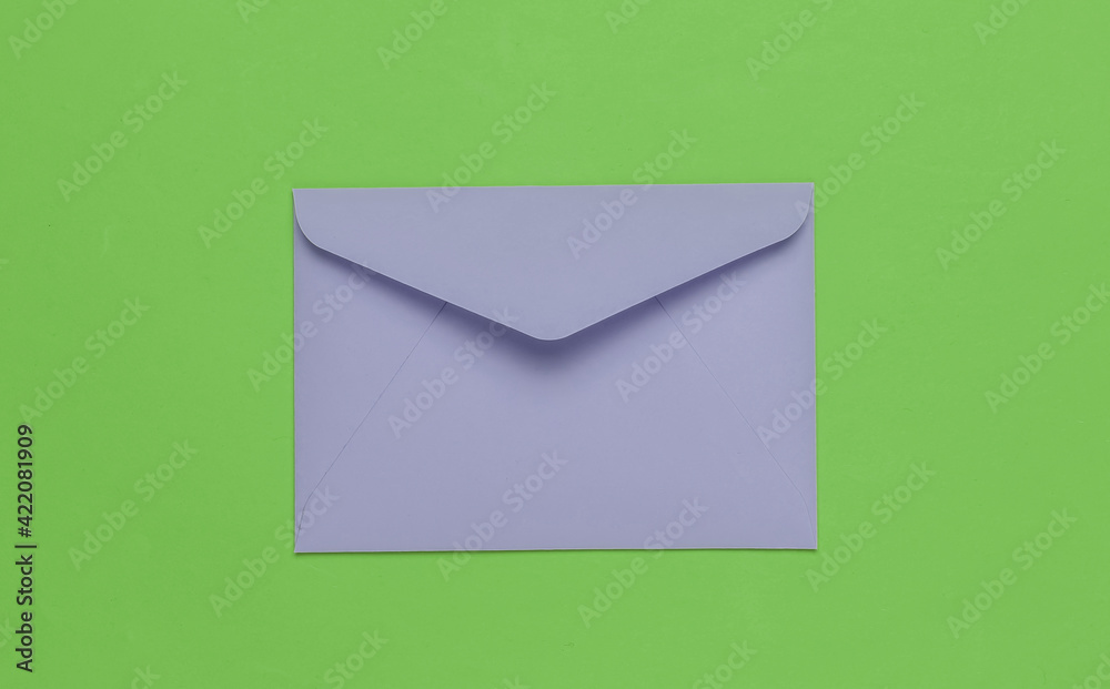 Envelope on green background. Flat lay mockup for valentines day, wedding or birthday. Top view Envelope on green background. Flat lay mockup for valentines day, wedding or birthday. Top view