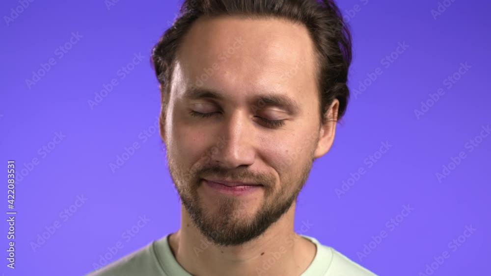 Inflexible man disapproving with no head sign, nods head disapprovingly. Denying, Rejecting, Disagree, Portrait of smiling guy on violet studio background. Inflexible man disapproving with no head sign, nods head disapprovingly. Denying, Rejecting, Disagree, Portrait of smiling guy on violet studio background.