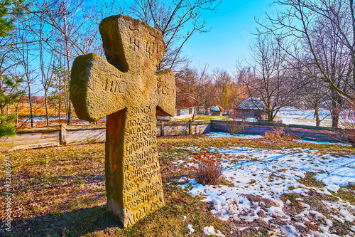 Historic grave cross in court of St Michael Church, Pyrohiv Skansen, Kyiv, Ukraine photo