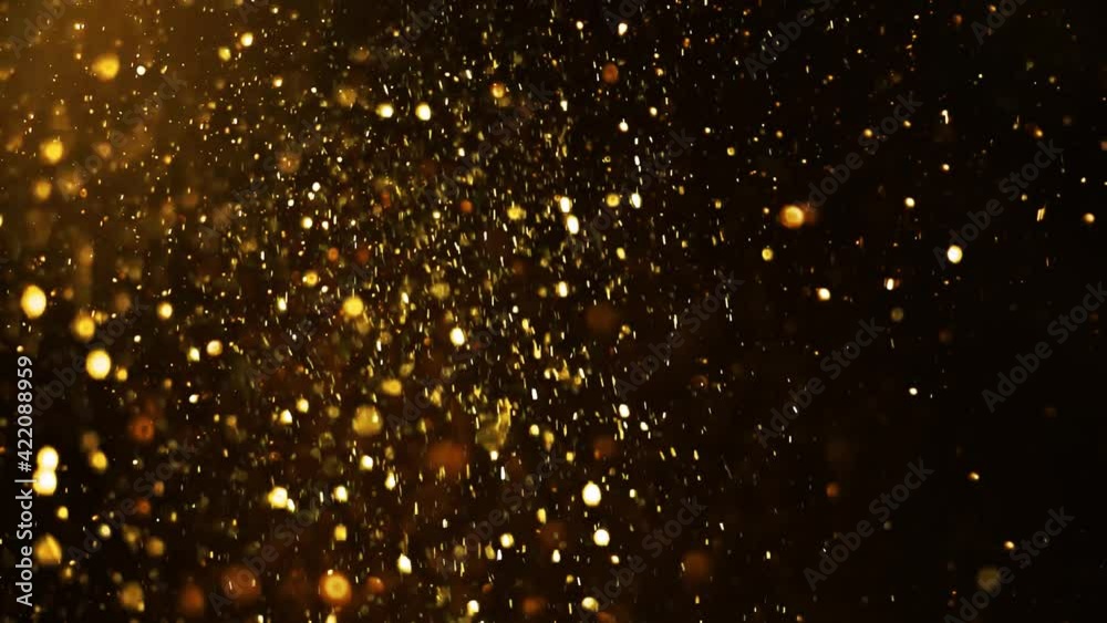 Gold dust particles fly in slow motion in the air lingering slowly. Dust Particles Background Bokeh Lights Background on Black Background 4k Footage Snow Particles Background.	