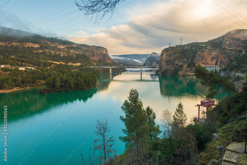 Fototapeta premium Natural environment of Cortes de pallás, in Valencia (Spain), with views of its mountains, Chirel Castle and its coniferous forests. On a sunny and cloudy day.
