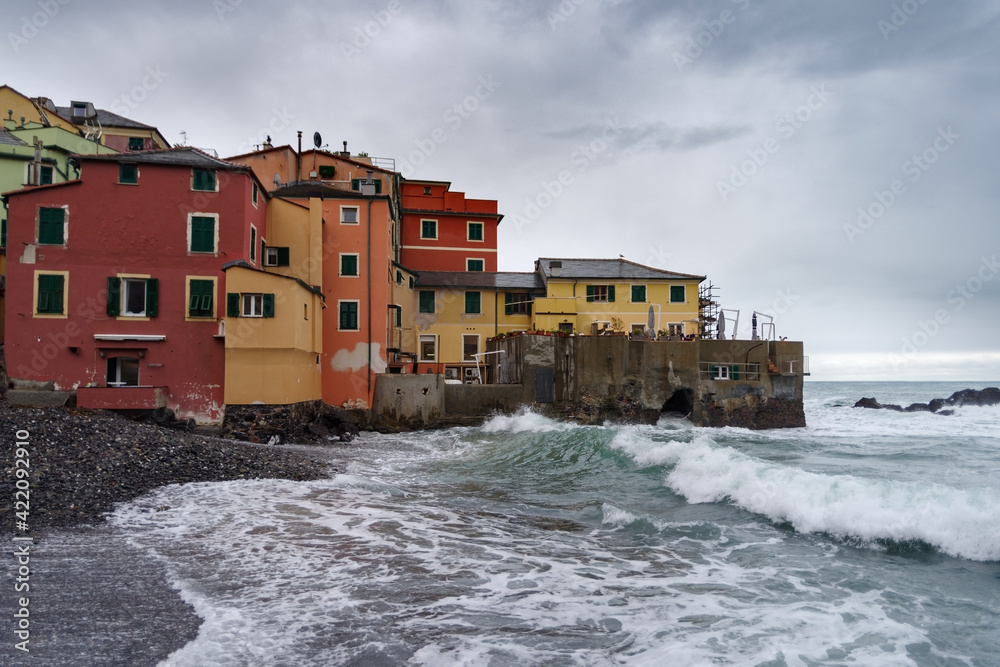 View of Boccadasse townscape by sea against storm clouds