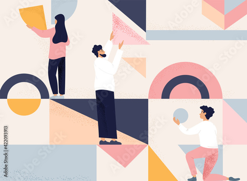 Team of three people arranging geometric shapes into an abstract design