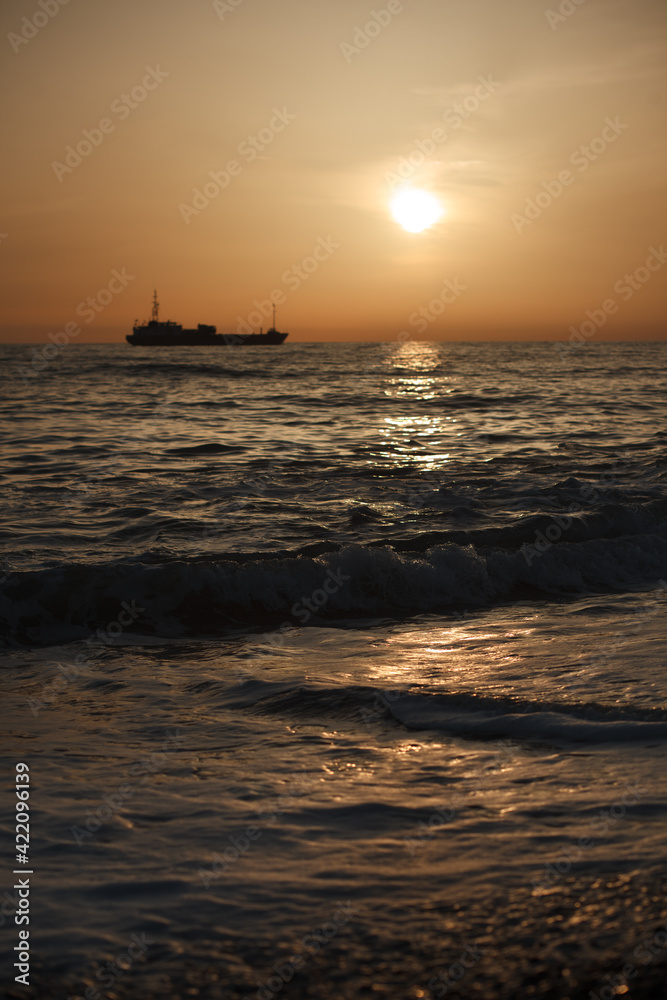 Beautiful waves on the black sea. Sunset