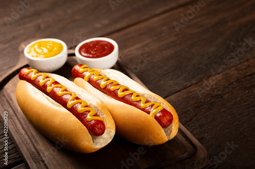 Hot dog with ketchup and yellow mustard. photo