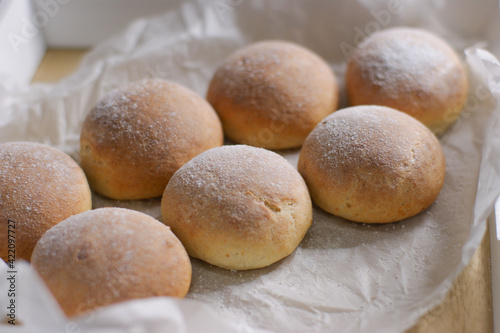 Fragrant puffy buns made of yeast dough in the oven.
