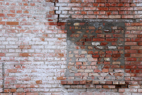 Blocked up a window in a red and white brick wall. Bricked up window. Old brick wall background. 