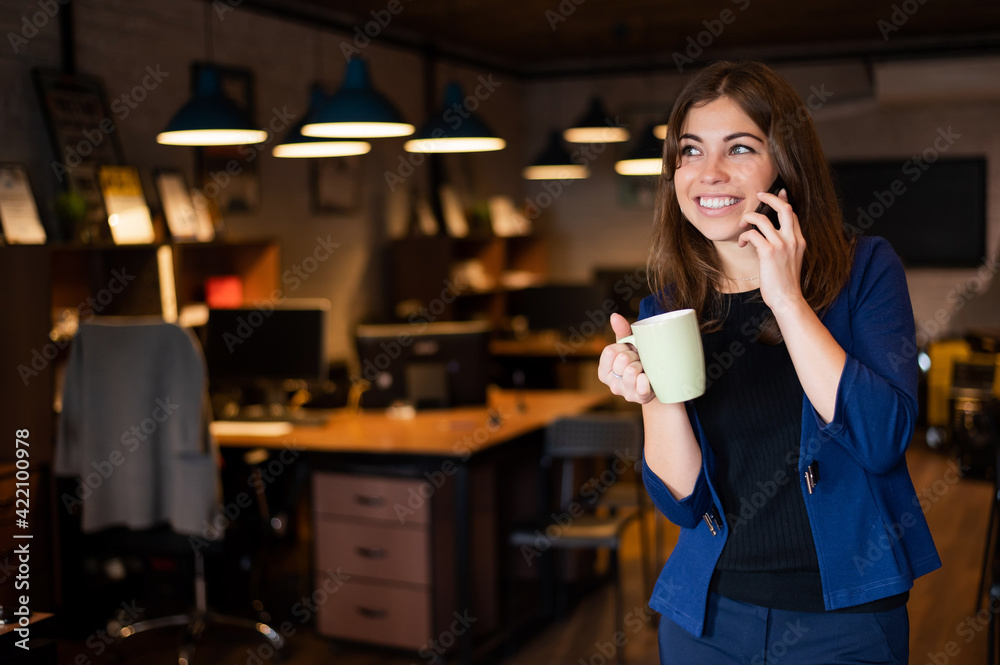 Woman using mobile phone at work in the office. Woman using mobile phone at work in the office.
