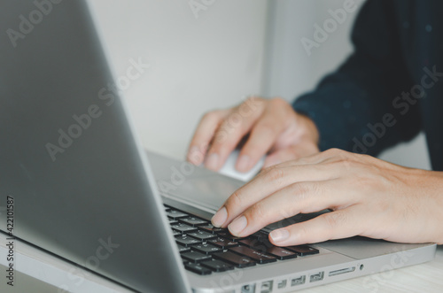 business man typing on keyboard computer laptop.
