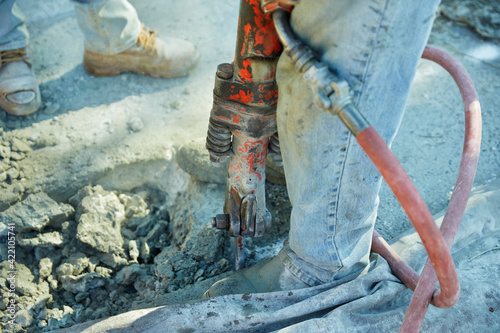 Foto Using proper safety technique, a construction worker prepares to us a jackhammer