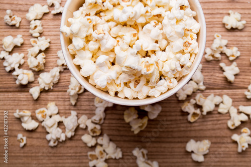 Heap of delicious popcorn isolated on wooden background. popcorn close-up