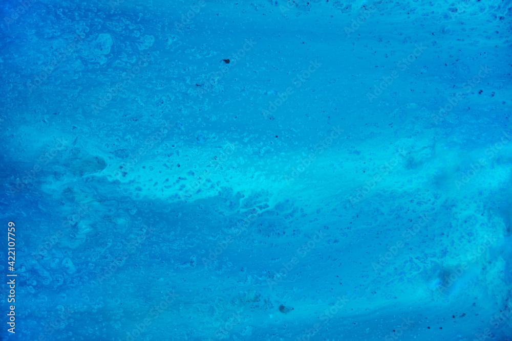 A blue texture reminiscent of water or ocean. Watercolor paints