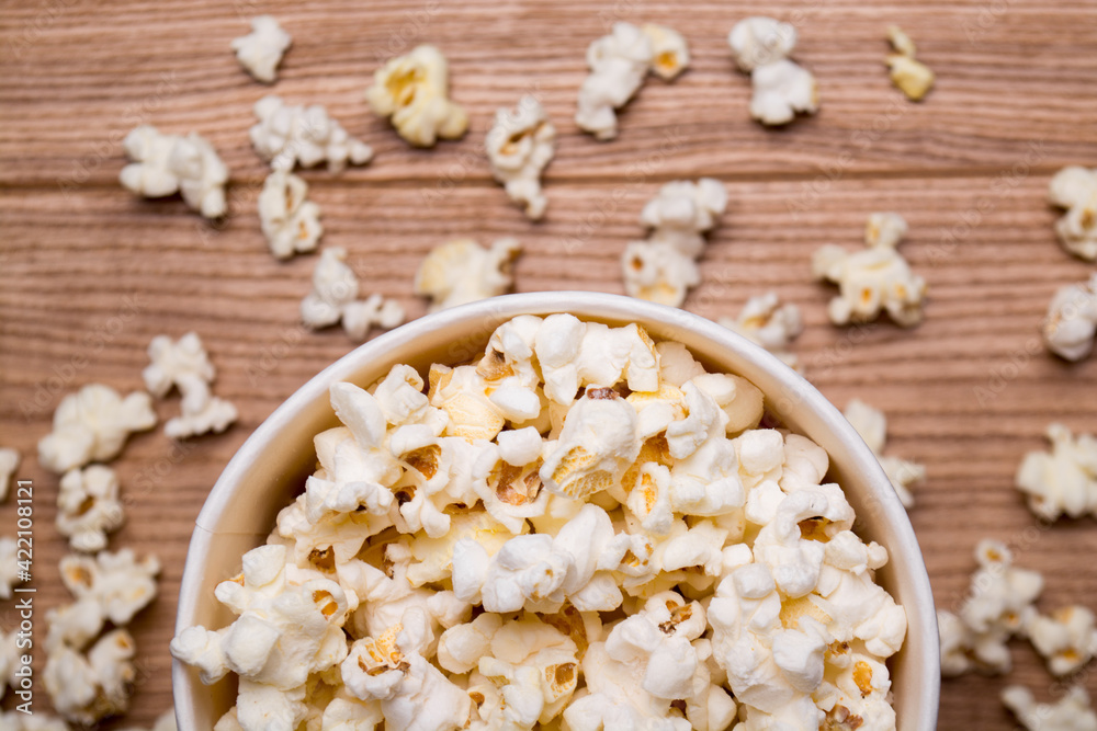 Heap of delicious popcorn isolated on wooden background. popcorn close-up Heap of delicious popcorn isolated on wooden background. popcorn close-up