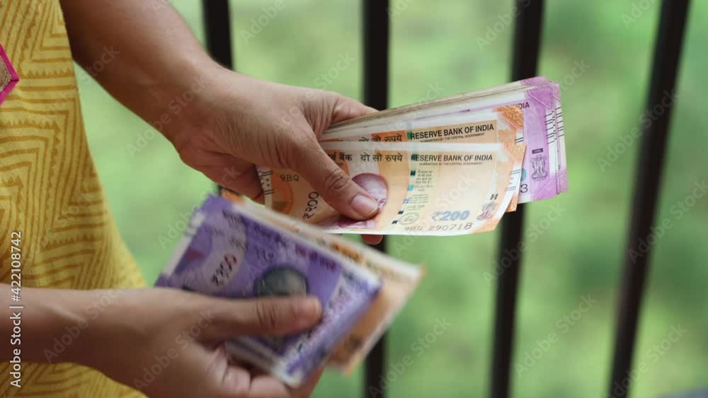 Counting Indian currency Rupee , hand giving Indian money 100, 200