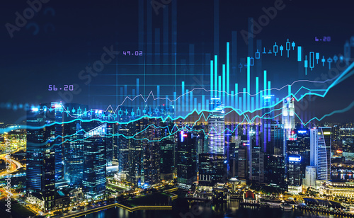 Graph changes lines and bars with skyscrapers at night photo