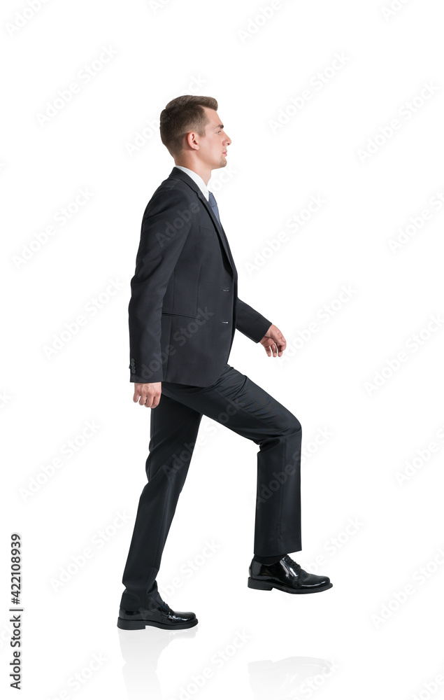 Young businessman is going up, isolated over white background Young businessman is going up, isolated over white background