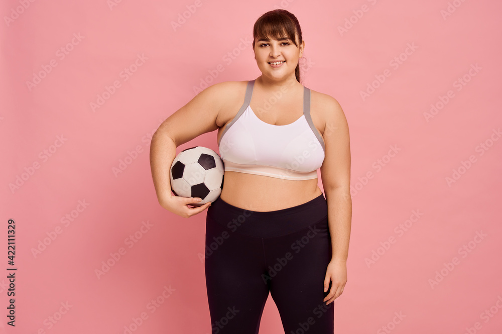 Overweight woman with football ball, body positive Overweight woman with football ball, body positive