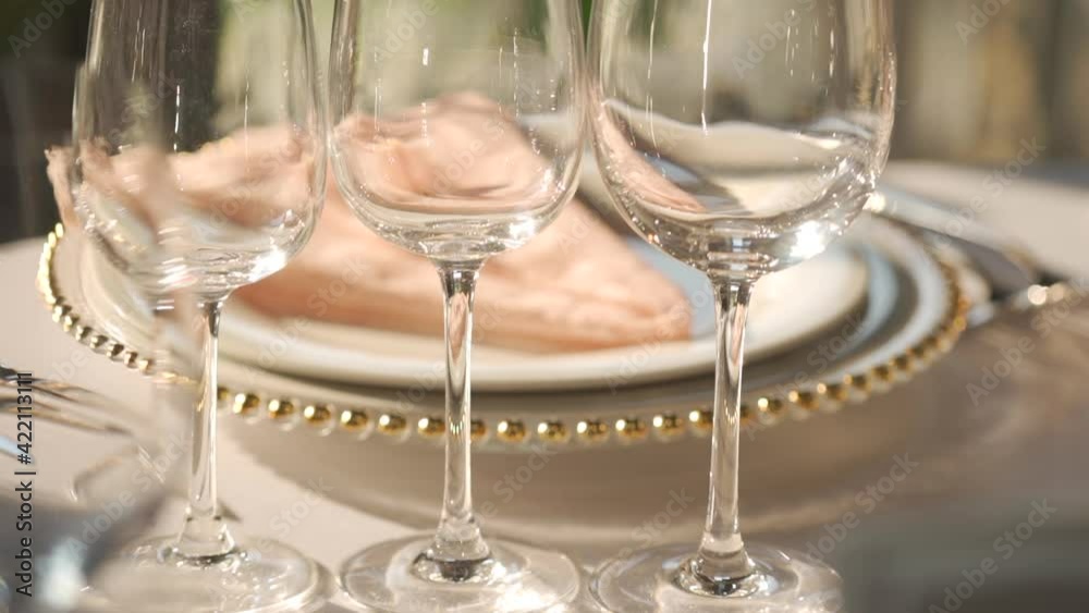 Festive serving of the table with glasses and plates Festive serving of the table with glasses and plates