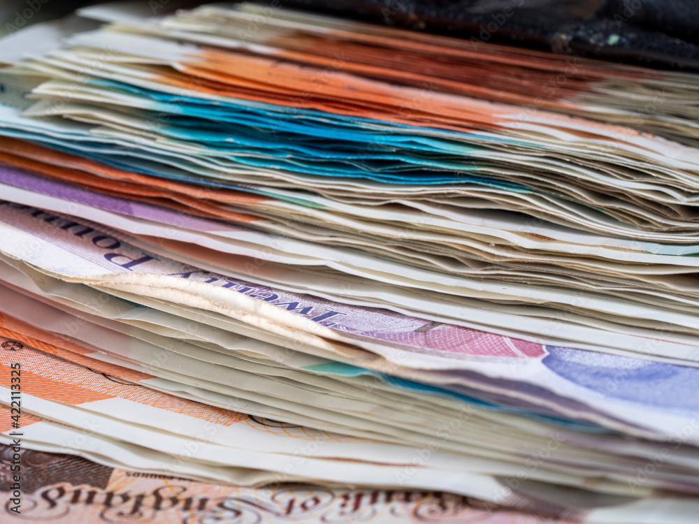 pile of British bank notes sterling cash pile of British bank notes sterling cash