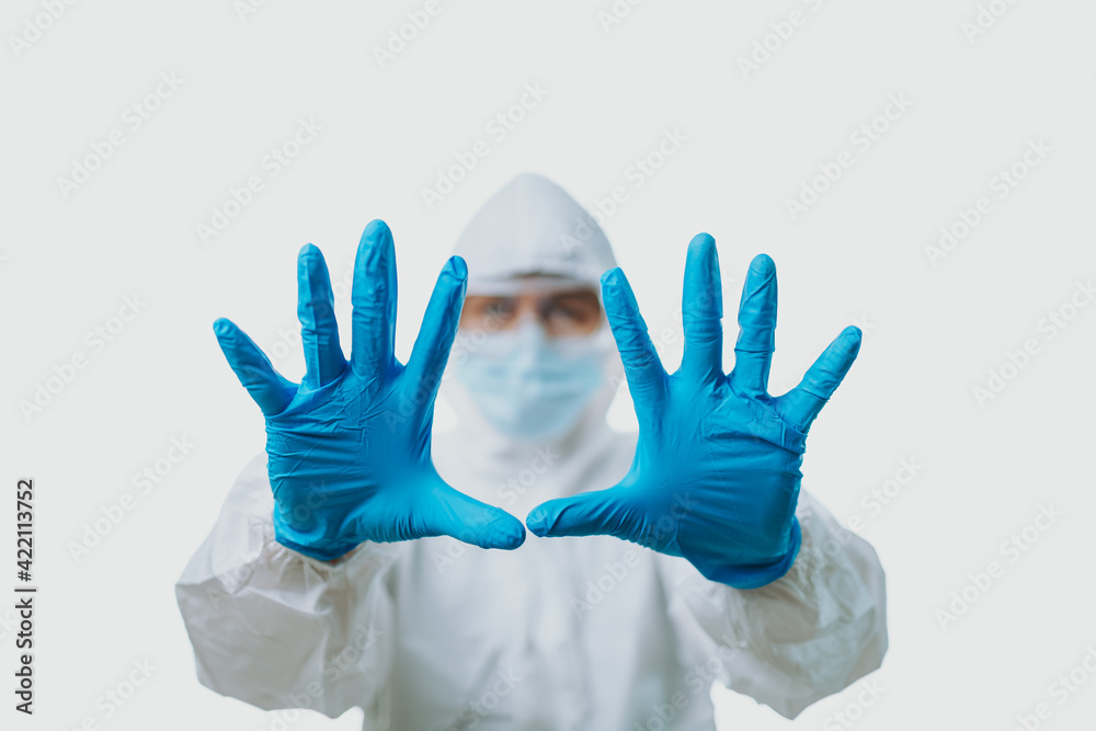 Fototapeta premium People wearing medical gloves and personal protective equipment, mask, goggle and suit to protect COVID-19 infection. hand signs or body language in the meaning of please stop; say no; or forbid; 