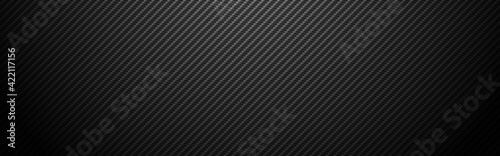 Carbon background wide. Realistic fiber texture. Dark futuristic backdrop with shadow. Metal cells design. Black composite material. Modern technology wallpaper. Vector illustration