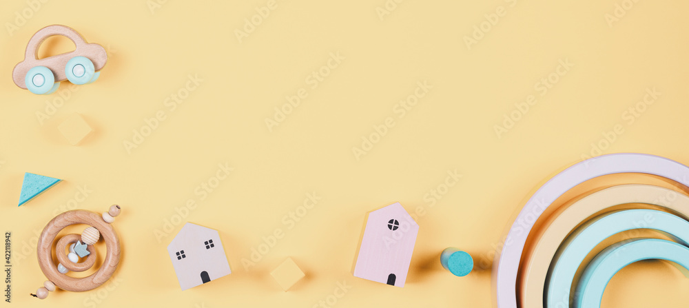 Baby kids toys frame on yellow background. Top view. Flat lay. Copy space for text Baby kids toys frame on yellow background. Top view. Flat lay. Copy space for text