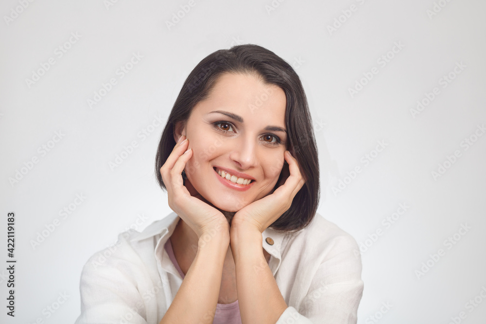 High key portrait of a young smiling multiethnic woman looking at the camera. High key portrait of a young smiling multiethnic woman looking at the camera.