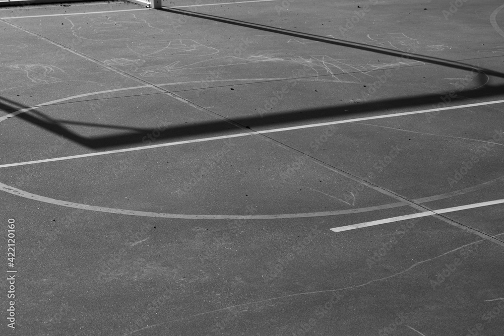 lines of the ground of a basketball field, white lines on gray asphalt, there are painted with chalk on the ground