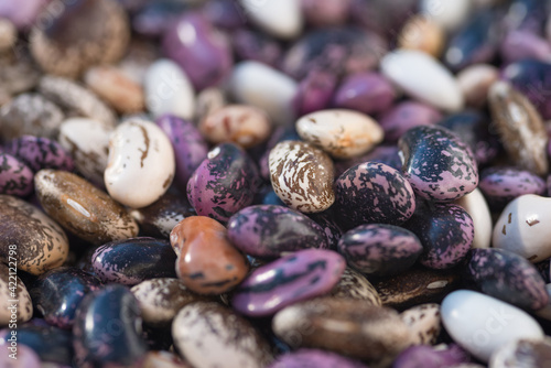 Shelled ripe seeds of kidney bean on heap. Pile of dry raw seeds of haricot (Phaseolus vulgaris) as natural background. Macro close-up. Organic farming, healthy food, BIO viands, back to nature. © Digihelion
