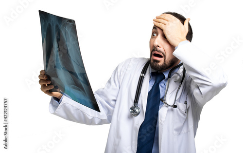 Doctor examining a chest radiography and looking shocked