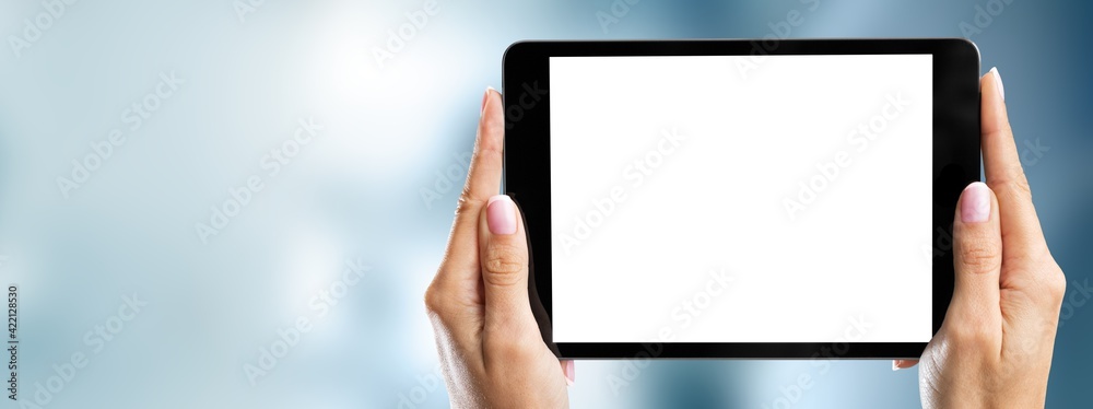 Human hands holding digital tablet with a white blank screen Human hands holding digital tablet with a white blank screen