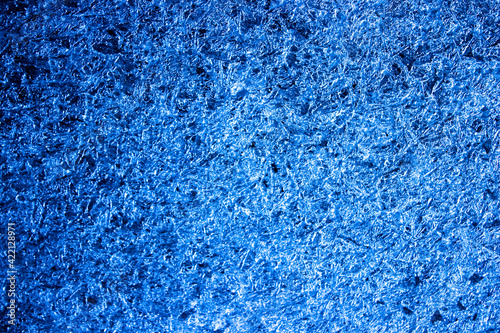 Abstract glazed background. Blue frozen water. Close up of iced water.