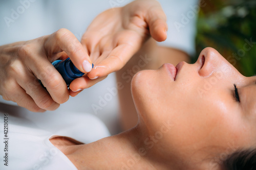 Retinol Treatment. Cosmetician Applying Retinol Serum on Woman   s Face