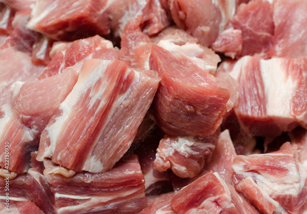 Raw pork chopped into small cubes and ready to marinade. Close-up