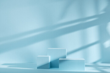 Blue background for product presentation with shadows and light. Empty podiums. Mockup.