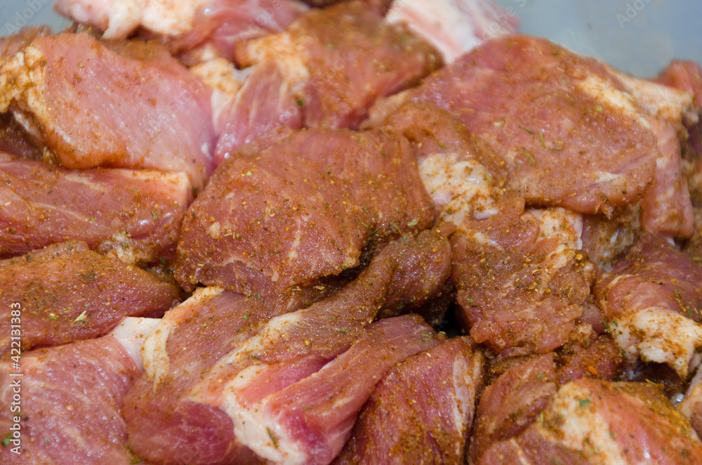 Raw pork chopped into small cubes and seasoned with spices. The process of making kemab and barbecue Raw pork chopped into small cubes and seasoned with spices. The process of making kemab and barbecue