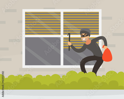 Male Burglar or Robber in Black Mask Breaking Into House Through Window Vector Illustration