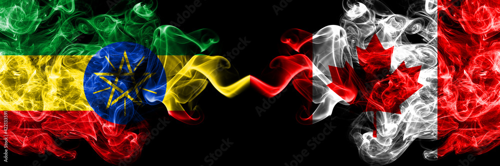 Ethiopia, Ethiopian vs Canada, Canadian smoky mystic flags placed side by side. Thick colored silky abstract smoke flags. Ethiopia, Ethiopian vs Canada, Canadian smoky mystic flags placed side by side. Thick colored silky abstract smoke flags.