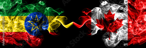 Ethiopia  Ethiopian vs Canada  Canadian smoky mystic flags placed side by side. Thick colored silky abstract smoke flags.