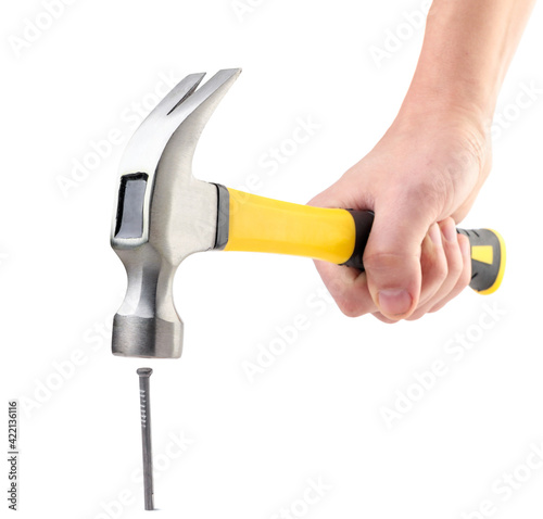 Fotografia, Obraz Hammer in hand hammering a nail on a white background. Isolated