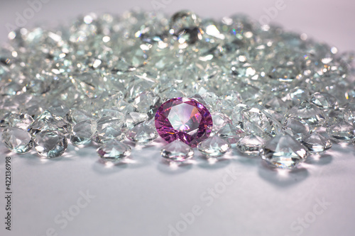 Pink diamonds are placed on a pile of white diamonds And keep turning. video 4k resolution shoot in studio.