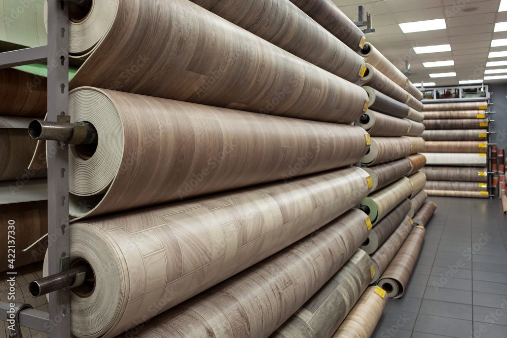 Rolls of new linoleum on the window of a hardware store. A large selection of linoleum Rolls of new linoleum on the window of a hardware store. A large selection of linoleum
