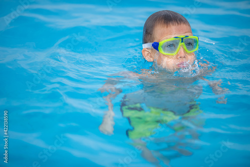 Cute little boy in a swimming pool