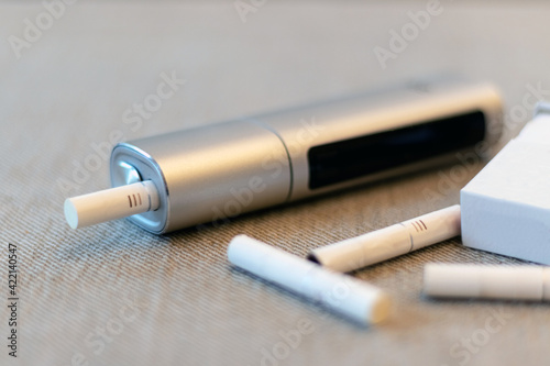 E-Cigs. System for tobacco. Close-up. Electric hybrid cigarette with heating pad, tobacco heating system.