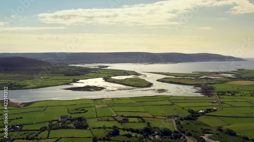 Irish Rural Landscape, view from Ballyvelaghan looking towards Fanore, Clare, Ireland, August 2020, Drone gradually tracks over fields facing West towards Clare. photo