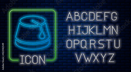 Glowing neon Turkish hat icon isolated on brick wall background. Neon light alphabet. Vector