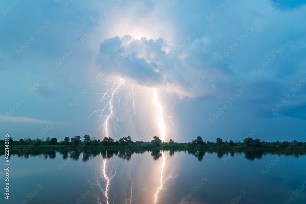 Bright flash of lightning over the river
