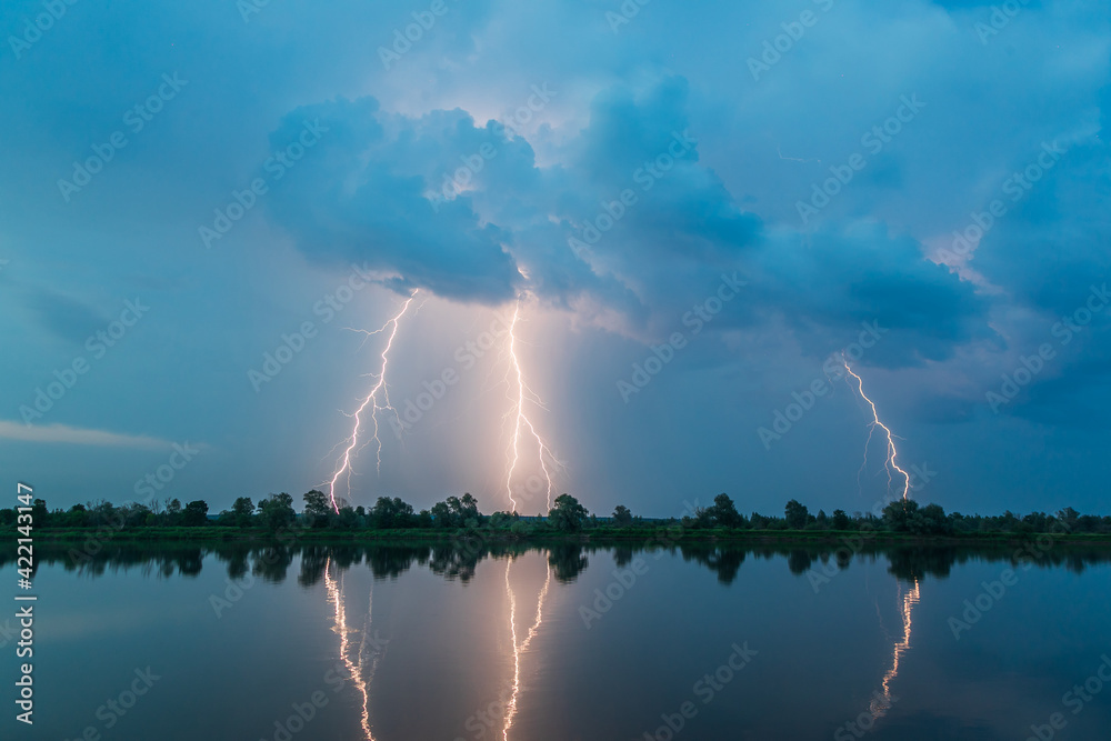 Bright flash of lightning over the river