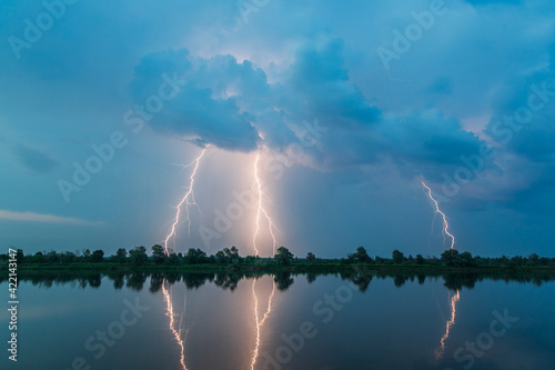 Obraz na płótnie Bright flash of lightning over the river w salonie