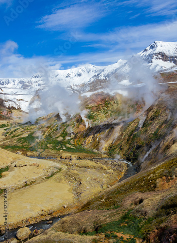 Spring landscape with columns of steam and gases in the Valley of Geysers.